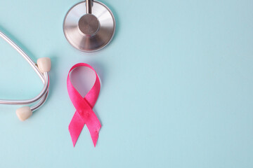 Pink Awareness Ribbon Arrange With Stethoscope On Light Blue Background