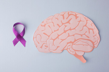 Purple Ribbon And Brain Paper Cutout On Light Blue Background. Support Mental Health Illness, Epilepsy, And Alzheimer.
