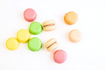 bunch of colorful macarons on a white surface