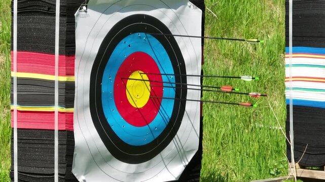 Archery arrows hitting target and bullseye with consistency, closeup of target