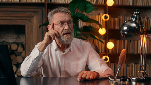 Old elderly Caucasian man thinking ponder new idea raise finger up senior mature businessman office indoors decision solution thoughtful male deep find answer business home thoughts pensive pensioner