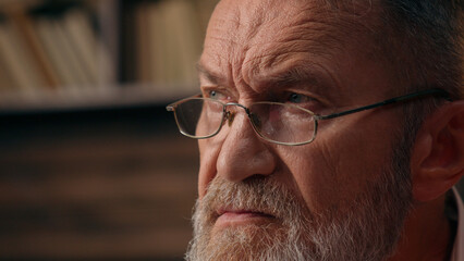 Close up face thoughtful old Caucasian man male business businessman thinking reflection contemplation inspiration writing notebook notes entrepreneur working writer author home office inside employee