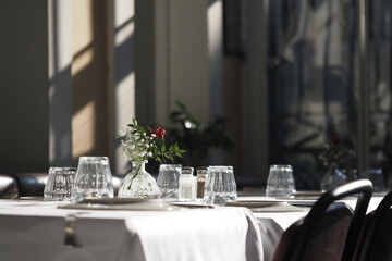 Elegant dining setup in bright restaurant during daylight hours