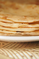 Delicious warm flatbreads stacked on a plate