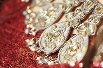 Ornate jewelry displayed on rich fabric during a cultural celebration
