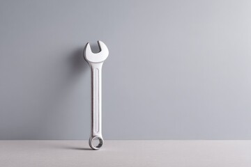 minimalistic setting with lone wrench on plain surface symbolizing service maintenance
