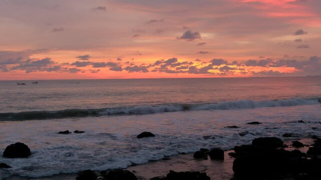 Sea horizon and scenic sunrise over splashing ocean waves and beach shore, tropical landscape 4K video