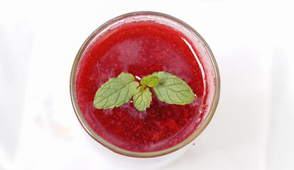 A glass of watermelon juice with ice on a white background. Summer juice concept. Selective focus