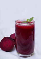 Smoothies with Beetroot, and mint leaves in glass with fresh vegetables on the white background. Detox, diet, healthy, vegetarian food and drink concept.