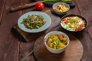 A set table, tzimmes, chelnt and couscous with dried fruits