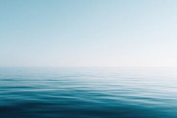 Obraz premium serene minimalistic photograph of vast tranquil ocean horizon under soft clear sky emphasizing significance of world