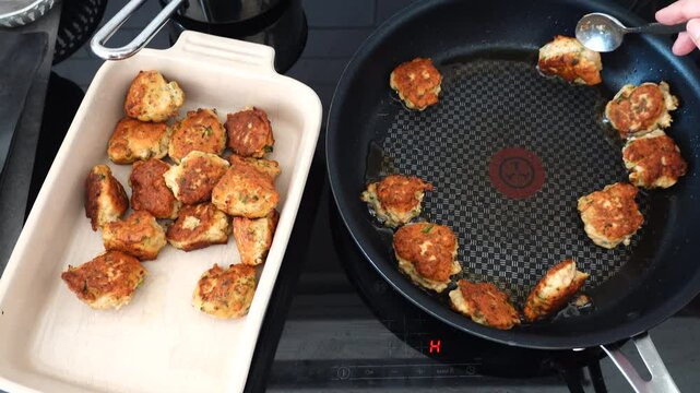 Stockholm, Sweden A cook fries Danish fish cakes, or Fiskefrikadeller, in oil over an induction stove.