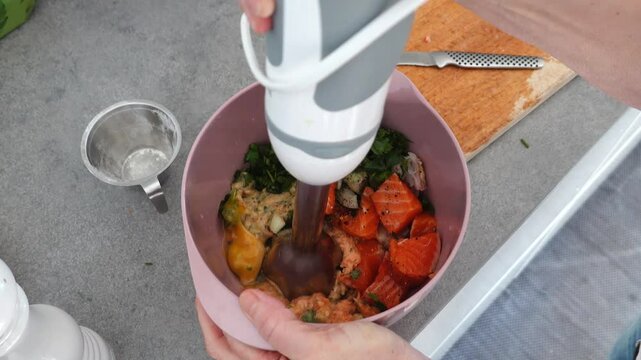 Stockholm, Sweden: A cook minces fish and spices with a hand blender to make Danish fish cakes, or Fiskefrikadeller. 