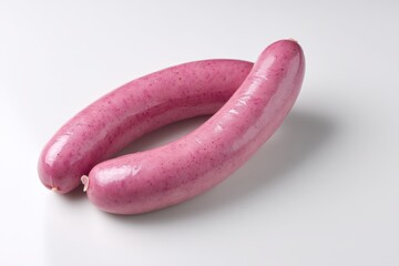 Two vibrant pink sausages arranged closely together on a clean white surface in studio light food photography