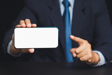 Businessman in suit showing thumbs down gesture representing disapproval, failure or rejection.
