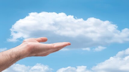 Hand holds soft fluffy cloud in the bright blue sky serene dreamlike image of hope and wonder
