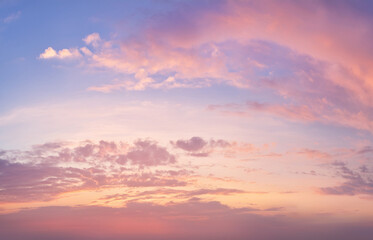 High-resolution image of a soft sunset sky with pastel pink, lavender, and gold tones. Gentle clouds and natural light glow. Dreamy and serene, suitable for beauty and wellness designs.