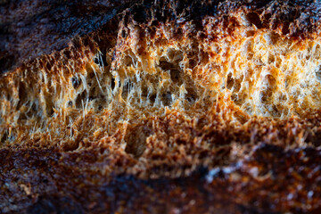 Bursting crust of freshly baked yeast-free bread, close up. Rustic sourdough bread