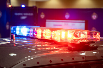 Blue and red police sirens on top of a patrol car. © Erman Gunes