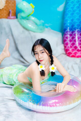 Cute Asian Girl Lying Down in Playful Summer-Themed Photo