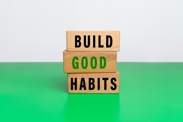 build good habits words symbol on wooden blocks isolated on white ang green background. motivational words concept