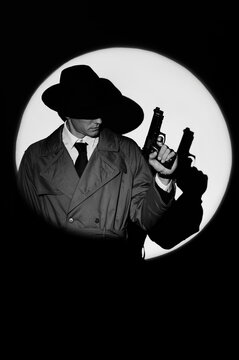 A dark silhouette of a male detective in a coat and hat with a gun in his hands in the noir style. A dramatic portrait in the style of detective films of the 1950s. The silhouette of a spy in a circle