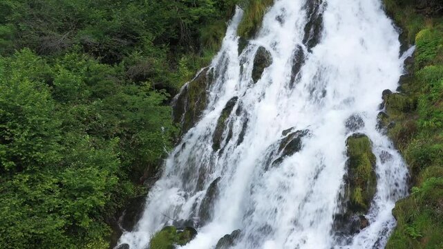 Mountain Elegance: Aerial Perspective of a White River Among Green Trees