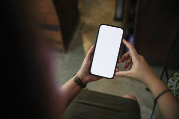 Close-up hand of Asian woman holding a blank smartphone screen.