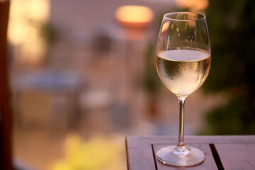 a glass of cold white wine and serving in the restaurant