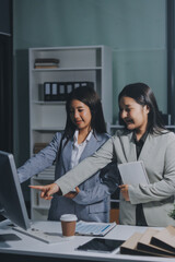 Fototapeta premium Asian Businesswoman Using laptop computer and working at office with calculator document on desk, doing planning analyzing the financial report, business plan investment, finance analysis concept.