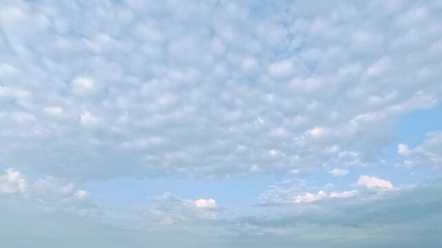 fast timelapse of fluffy clouds on bright day