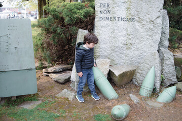 Child explores historical war relics in a park