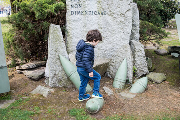 Child explores historical memorial in park setting