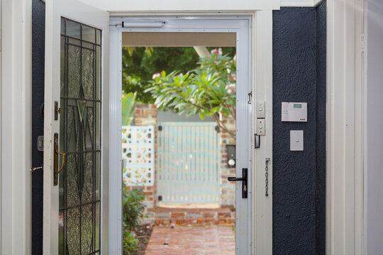 Looking out of house through security door, with alarm system visible