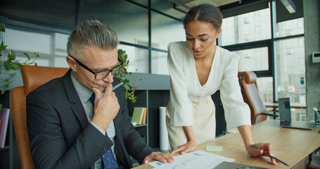 Businesswoman discussing data with businessman