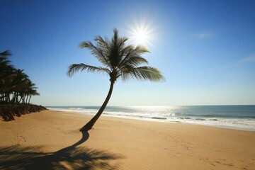 Obraz premium Tropical beach scene with golden sand, leaning palm tree, and sunlight over blue sky. Ocean waves gently hit the shore under a serene summer atmosphere. Perfect for travel, relaxation, and vacation