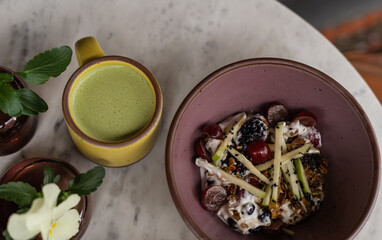 Fresh fruit parfait and drinks on marble table