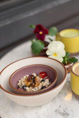 Fresh fruit muesli and drinks on marble table