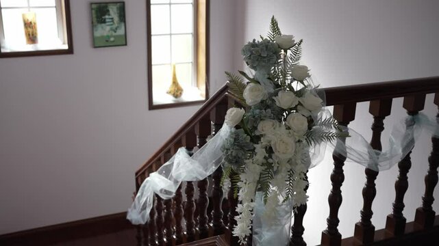 Elegant staircase decorated with white roses and tulle for wedding location irrelevant