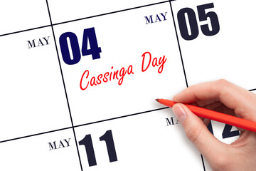 May 4. Hand writing text Cassinga Day on calendar date. Save the date.