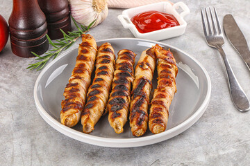 Grilled meat sausages wrapped bacon