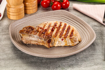Grilled pork loin steak with bone