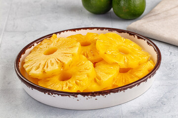 Sweet canned pineapple slices in syrope