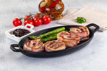 Tasty grilled pork medallion with bacon