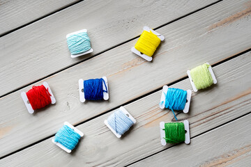 Handicraft threads remain on the wooden surface