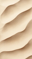 Soft undulating sand dunes reflect the warm glow of dawn in an inviting desert landscape, highlighting intricate patterns formed by the wind and time