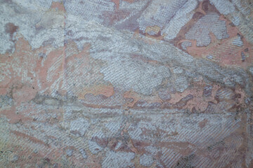Aged grunge stone wall texture reveals a rough brown pattern