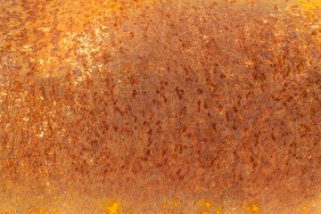 A grungy, old iron surface with a textured, weathered rust pattern creates a rusty metal background