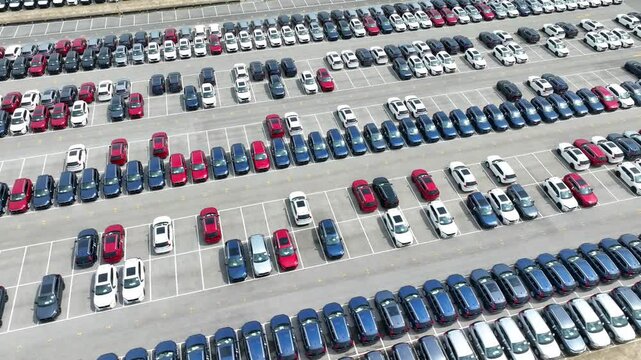 Capturing the precision of modern parking facilities, this aerial view shows parallel rows of cars, creating a sense of uniformity and harmony in a high-density urban environment.
