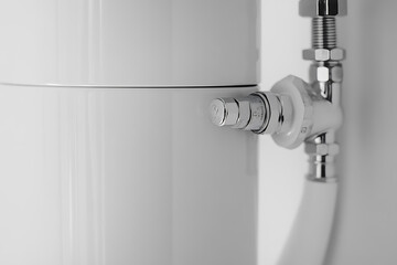 Plumber installing a water heater in a home. Featuring precision and technical skills